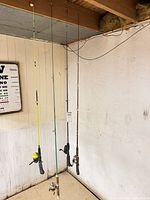 Four rods hanging from ceiling showing overall lengths and attached reels