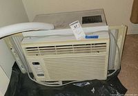 Front view of GoldStar M5400 window AC showing grille, control panel, attached power cord, side mounting panels