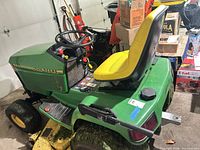 Full view of mower showing seat, deck and body