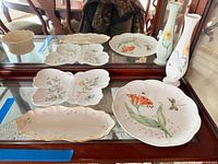 Group shot of all Lenox pieces on glass shelf mirror backdrop