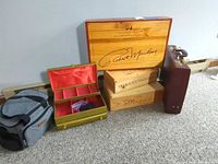 Group shot of all six items: cooler bag, jewelry box, three wine crates, briefcase