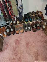 Full view of shoe lot on closet floor and rack