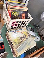 Crate of records with Bruce Willis and Bill Cosby albums visible
