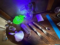 All items in lot under UV light highlight uranium glass juicer and show overall condition