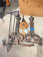 Lot overview showing andirons, two pokers and bellows