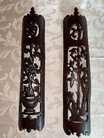 Both carved hardwood panels side by side showing motifs and finish