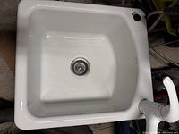 Top view of sink showing basin, drain and faucet
