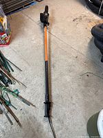 Full view of Remington electric pole saw on floor