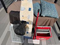 Group shot showing ironing board, dryer rack, bucket, mop, laundry bag, and pillows
