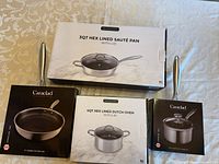 All four boxed cookware pieces together