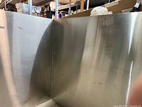 L-shaped stainless backsplash panels, interior corner view