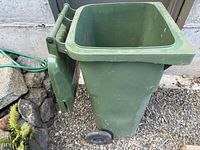 Side view showing hinged lid open, interior visible, wheels and body