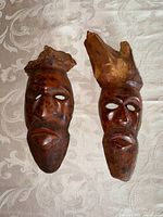 Both burl wood masks side by side showing overall design and condition