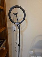 Ring light on tripod with phone holder visible
