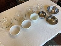 All ten bowls laid out showing variety of materials and sizes