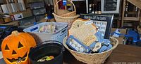 Overall lot showing ceramic pumpkin, LED lights box, plaques, faux fruit basket and wicker baskets