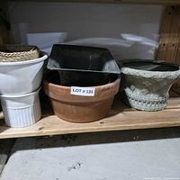 group of assorted planters on shelf