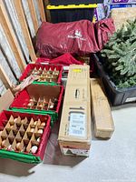 Overview of tree storage bag, ornament bins, cardboard tree boxes, plastic totes