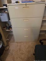 Front view of beige metal file cabinet showing four drawers