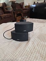 Front view of both Bose speakers showing curved grilles and logos