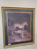 Full view of framed leopard print on wall