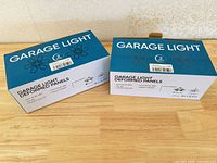 Two blue retail boxes labeled Garage Light