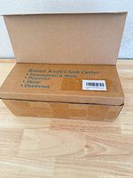 Closed brown carton labeled Round Knife Cloth Cutter