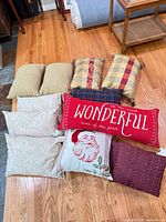 Group shot of all nine pillows on wooden floor