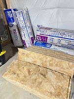 Overall view showing three Johns Manville R-13 insulation bundles and loose batts