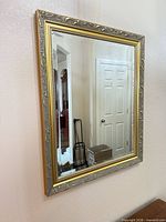 Full view of framed wall mirror on wall