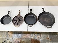 All four Lodge cast iron pieces side-by-side for size comparison