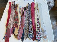 Full group of neckties laid flat showing variety of colors and patterns