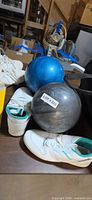 Blue and gray bowling balls, Brunswick shoes, partial view of bag