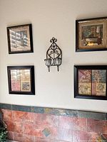 Overall view of four framed prints and central metal tealight holder