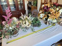 All four silk flower arrangements on table for overall view