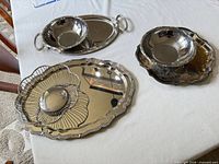 Group shot of five silver-plated pieces on table