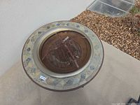 Top view of fire pit table showing tile border and inner bowl