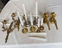 All candlesticks, sconces, shades and candles laid out