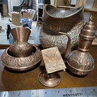 Front view of all five copper pieces showing overall condition and scale