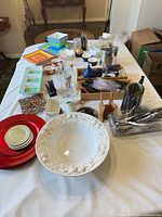Overall lot on table with plates, bowl, utensils, glassware, serveware