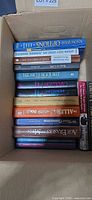 Books stacked in open box showing titles such as Know Your Options, Eat Great Lose Weight and The South Beach Diet
