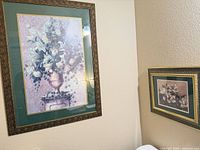 Both framed prints on wall showing size difference
