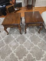 Both end tables front view showing drawers and legs