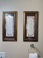 Pair of framed scripture wall art pieces mounted on wall