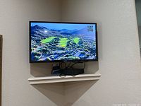 Samsung 32-inch TV wall-mounted, screen on