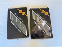 Two dearlithe 4-piece steak knife boxes closed