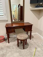 Front view of dressing table, mirror, and stool