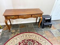 Front view of console table showing drawers, legs and hardware