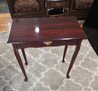 Full view of end table showing top, legs and drawer