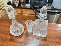 Group shot showing both decanters with stoppers and small vase